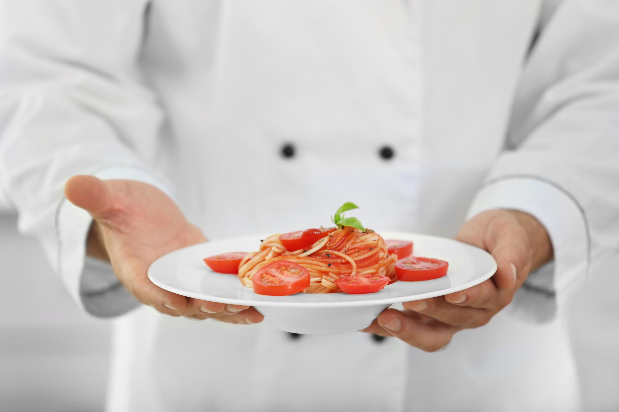 Chef preparing modern plated dish with clean mise-en-place